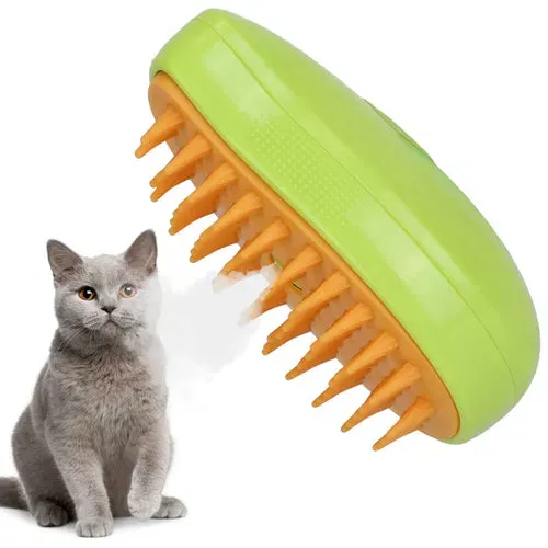 Green and orange grooming brush beside a grey cat